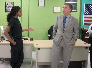 Congressman Garcia listened attentively as security trade student, Kenisha Davis, discussed her involvement with the community.