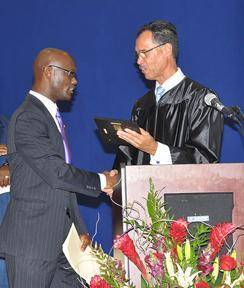 HJCC Center Director Luis Cerezo, right, presents an award of appreciation to HJCC Commencement speaker State Representative Kionne L. McGhee. Congressman Joe Garcia was also in attendance.