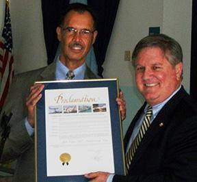 Homestead Job Corps Center Director Luis Cerezo receives a proclamation from Frank Balzebre, aide to Miami-Dade County Mayor Carlos Gimenez.