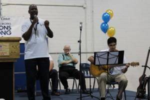 Acosta Job Corps Center Life Specialist Paul Harris, far left, and Career Exploration Specialist Cristobal Barajas, far right, performed “A Little Help From My Friends” at the Acosta Job Corps Center 50th Anniversary kick-off assembly.