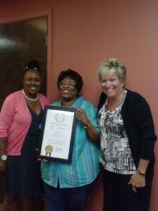 From left, Executive Director Melonee Williams, 2014 DSP of the Year Award recipient Vickie Brooks and Director of Operations/General Manager Lori West celebrate Ms. Brook’s win with a proclamation issued by Texas Governor Rick Perry.